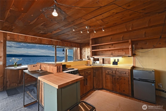 8204 Naketa Beach Walk, Mukilteo, WA 98275 - kitchen featuring freestanding refrigerator, butcher block counters, a water view, wooden walls, and wood ceiling