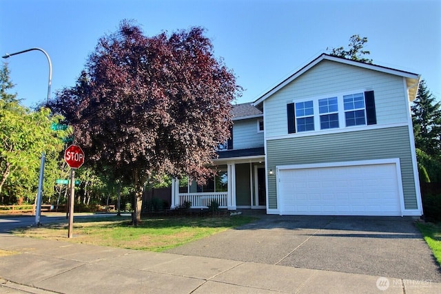 831 SW 364th Pl, Federal Way, WA 98023 - traditional home featuring an attached garage, covered porch, driveway, a front yard, and a shingled roof