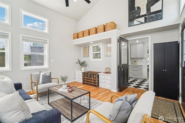 603 NW 52nd St, Seattle, WA 98107 - living room with high vaulted ceiling, a ceiling fan, light wood-style flooring, and baseboards