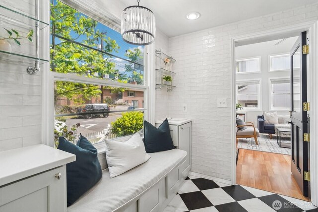 603 NW 52nd St, Seattle, WA 98107 - living area with plenty of natural light, tile patterned floors, a chandelier, brick wall, and recessed lighting