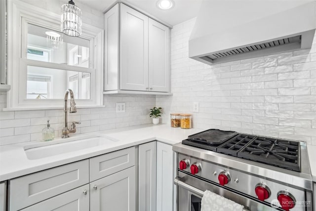 603 NW 52nd St, Seattle, WA 98107 - kitchen featuring high end stainless steel range, a sink, premium range hood, tasteful backsplash, and light countertops