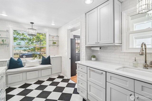 603 NW 52nd St, Seattle, WA 98107 - kitchen with a sink, a chandelier, light countertops, backsplash, and recessed lighting