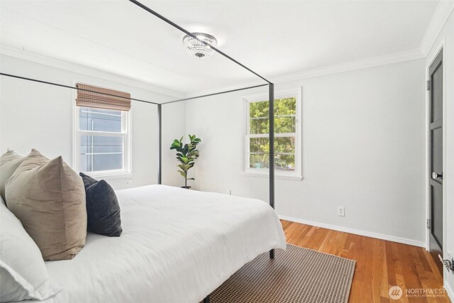 603 NW 52nd St, Seattle, WA 98107 - bedroom featuring crown molding, multiple windows, baseboards, and wood finished floors