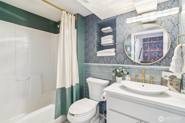 603 NW 52nd St, Seattle, WA 98107 - bathroom featuring wallpapered walls, vanity, shower / bath combination with curtain, toilet, and tile walls