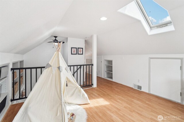 603 NW 52nd St, Seattle, WA 98107 - additional living space featuring a skylight, wood finished floors, vaulted ceiling, and a ceiling fan