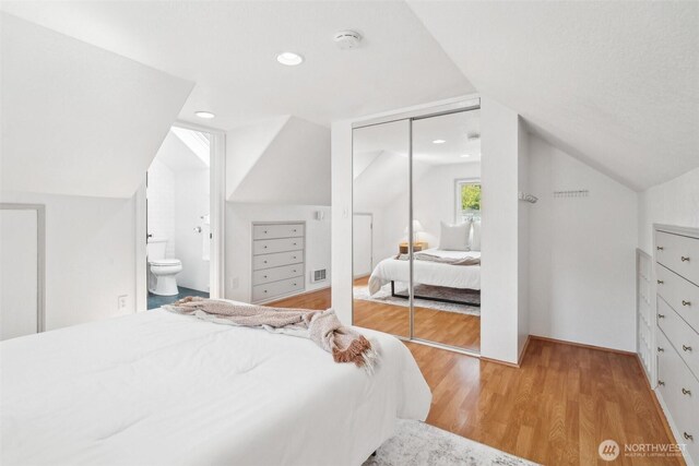 603 NW 52nd St, Seattle, WA 98107 - bedroom featuring vaulted ceiling, light wood-type flooring, a closet, and ensuite bathroom