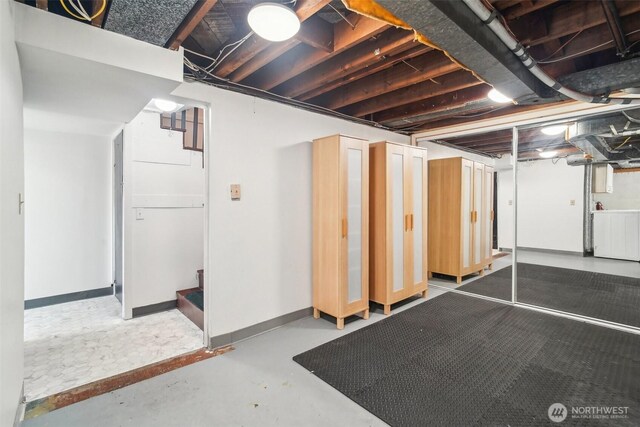 603 NW 52nd St, Seattle, WA 98107 - unfinished basement featuring washer / dryer and baseboards