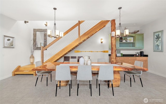 62 E N Bay Rd, Allyn, WA 98524 - dining space featuring a chandelier, baseboards, light tile patterned floors, and stairway