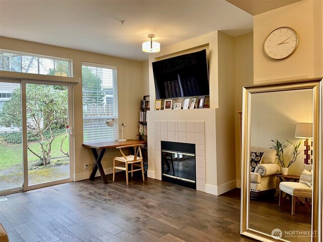 4459 249th Ter SE Unit 8-5, Issaquah, WA 98029 - living room featuring dark wood finished floors, a tiled fireplace, and baseboards