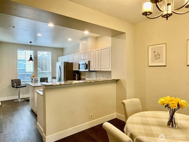 4459 249th Ter SE Unit 8-5, Issaquah, WA 98029 - kitchen with appliances with stainless steel finishes, baseboards, dark wood-style floors, white cabinets, and recessed lighting