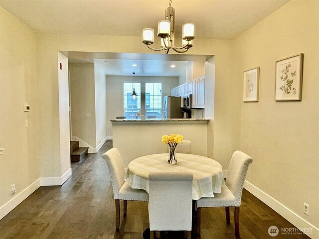 4459 249th Ter SE Unit 8-5, Issaquah, WA 98029 - dining area featuring baseboards, dark wood-style floors, and a chandelier