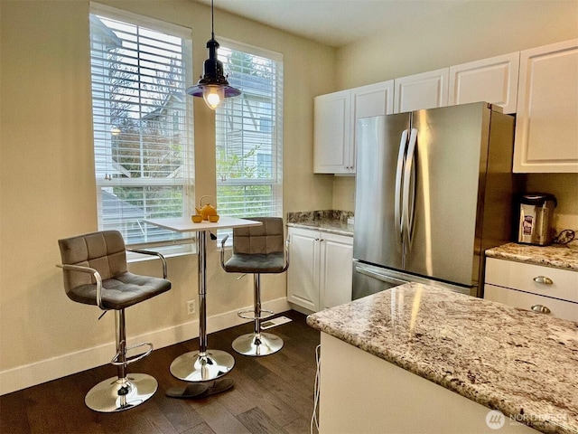 4459 249th Ter SE Unit 8-5, Issaquah, WA 98029 - kitchen with freestanding refrigerator, dark wood-style flooring, white cabinets, and healthy amount of natural light