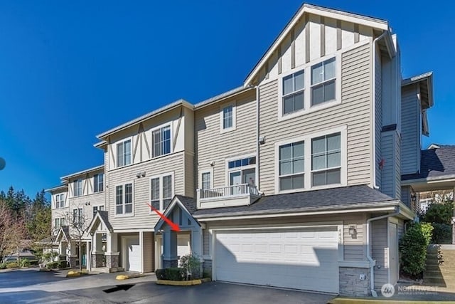 4459 249th Ter SE Unit 8-5, Issaquah, WA 98029 - view of property with a garage and asphalt driveway