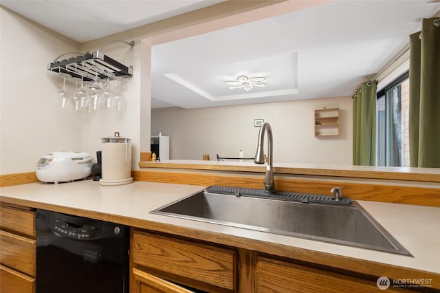 8407 18th Ave W Unit 6-104, Everett, WA 98204 - kitchen featuring black dishwasher, brown cabinets, a sink, light countertops, and a tray ceiling
