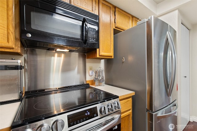 8407 18th Ave W Unit 6-104, Everett, WA 98204 - kitchen with stainless steel appliances, light countertops, brown cabinets, and baseboards