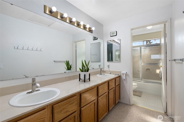 8407 18th Ave W Unit 6-104, Everett, WA 98204 - bathroom with double vanity, toilet, combined bath / shower with glass door, and tile patterned floors