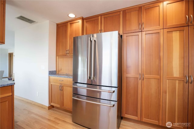8082 Daniel Pl NW, Silverdale, WA 98383 - kitchen featuring freestanding refrigerator, light wood-style flooring, dark stone countertops, brown cabinets, and recessed lighting