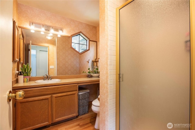 8082 Daniel Pl NW, Silverdale, WA 98383 - full bathroom featuring toilet, vanity, a shower stall, and wood finished floors
