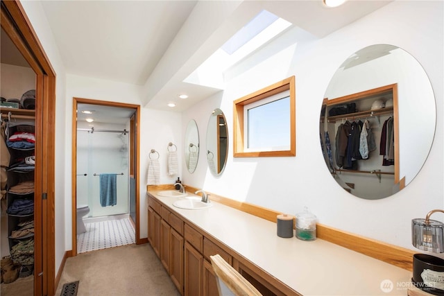 8082 Daniel Pl NW, Silverdale, WA 98383 - bathroom with a spacious closet, a shower stall, double vanity, recessed lighting, and toilet
