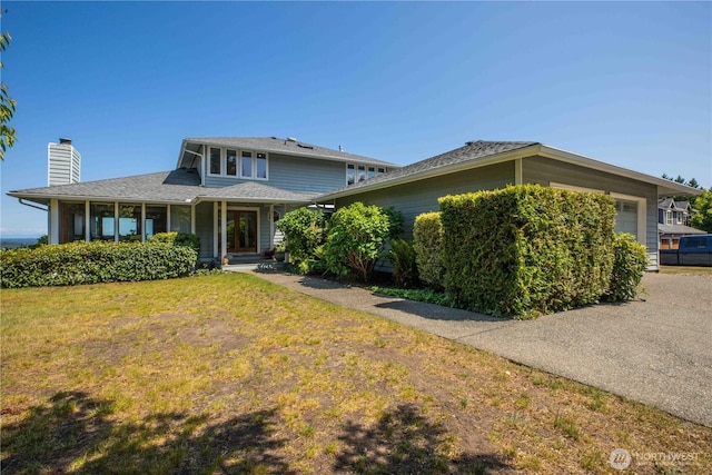 8082 Daniel Pl NW, Silverdale, WA 98383 - view of front of home with an attached garage, a chimney, and a front yard