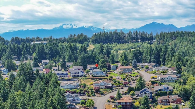 8082 Daniel Pl NW, Silverdale, WA 98383 - drone / aerial view of a mountain backdrop and a forest