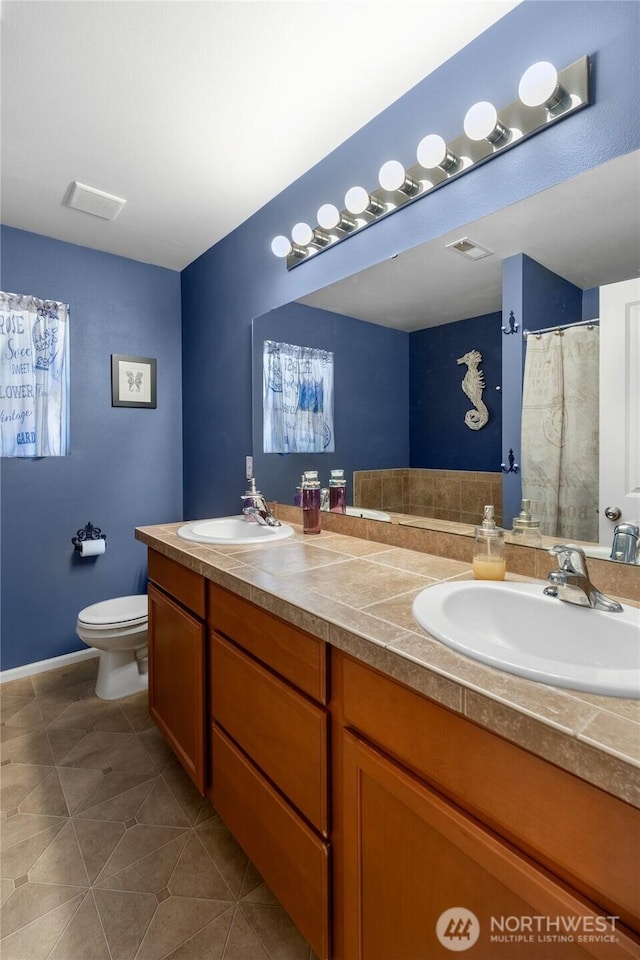 782 Fenway Ln SW, Tumwater, WA 98512 - bathroom featuring double vanity, toilet, and tile patterned flooring