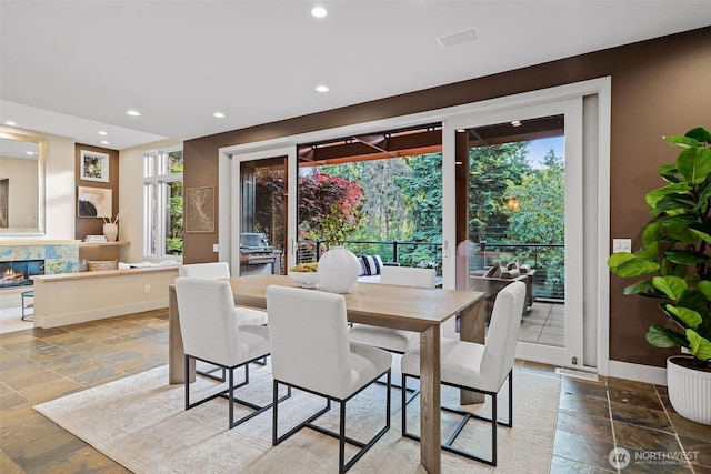 530 Alexander Ave, Kirkland, WA 98033 - dining space with stone tile floors, recessed lighting, baseboards, and a glass covered fireplace