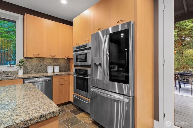 530 Alexander Ave, Kirkland, WA 98033 - kitchen featuring appliances with stainless steel finishes, tasteful backsplash, light stone counters, dark stone finish flooring, and recessed lighting