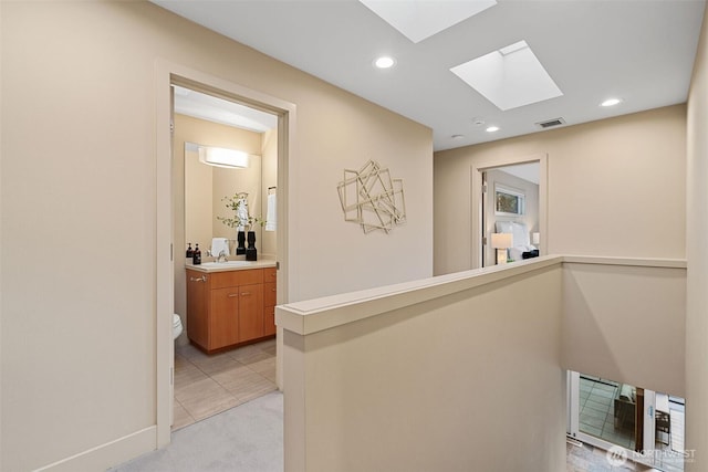 530 Alexander Ave, Kirkland, WA 98033 - corridor featuring a skylight, recessed lighting, light carpet, and a sink