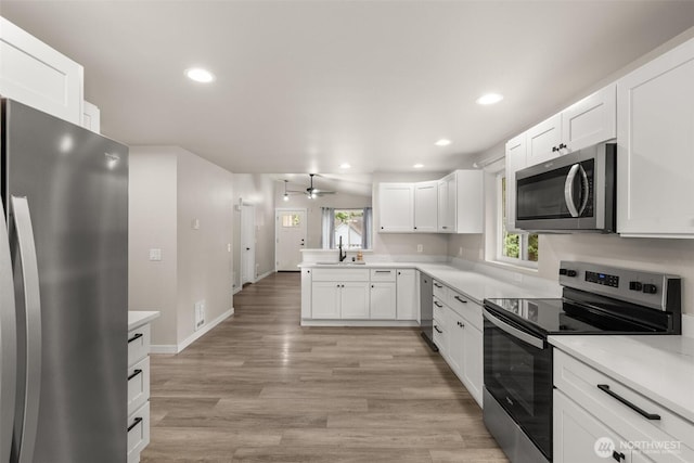 18822 Rampart Dr SE, Yelm, WA 98597 - kitchen with appliances with stainless steel finishes, a sink, a ceiling fan, recessed lighting, and light countertops