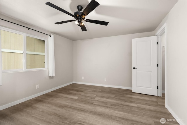 18822 Rampart Dr SE, Yelm, WA 98597 - spare room featuring a ceiling fan, wood finished floors, and baseboards