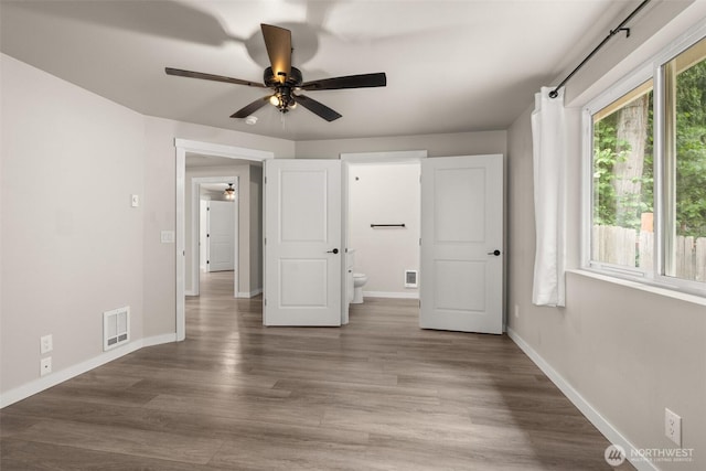 18822 Rampart Dr SE, Yelm, WA 98597 - unfurnished bedroom featuring baseboards, wood finished floors, and ceiling fan