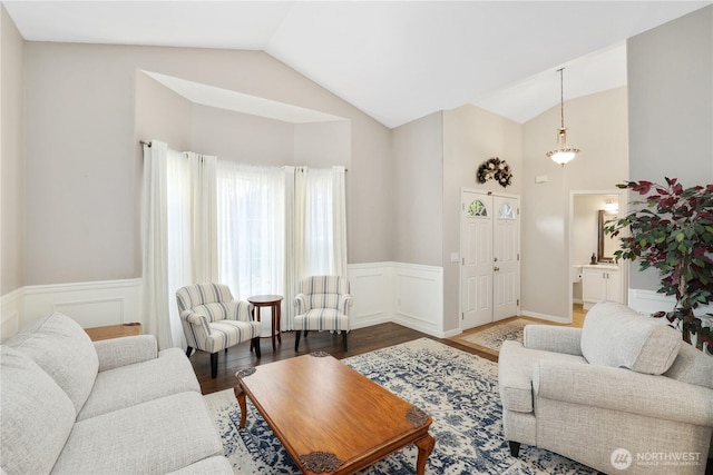 23813 109th Street Ct E, Buckley, WA 98321 - living area with vaulted ceiling, a wainscoted wall, and wood finished floors