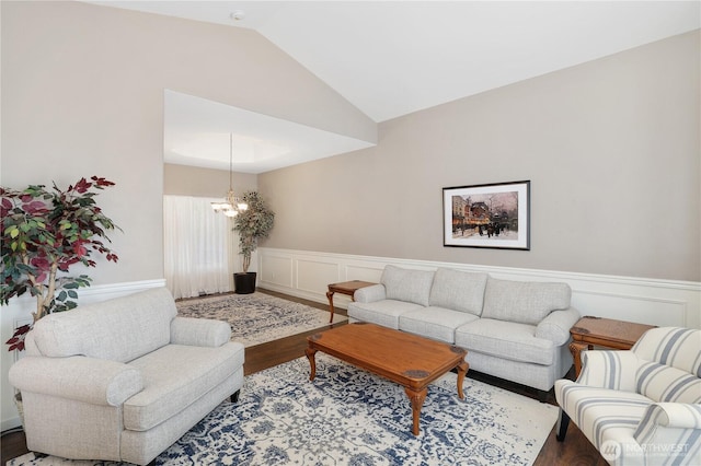 23813 109th Street Ct E, Buckley, WA 98321 - living room featuring wood finished floors, a chandelier, a wainscoted wall, lofted ceiling, and a decorative wall
