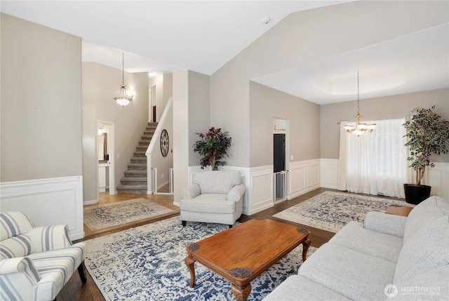 23813 109th Street Ct E, Buckley, WA 98321 - living area with a chandelier, stairway, wood finished floors, wainscoting, and vaulted ceiling