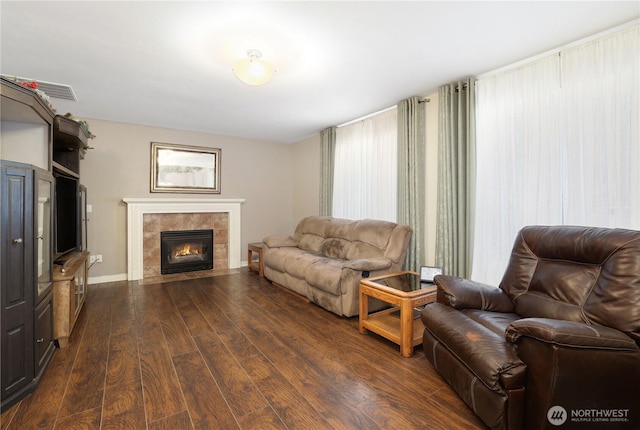 23813 109th Street Ct E, Buckley, WA 98321 - living area with dark wood-style floors, a tile fireplace, and baseboards