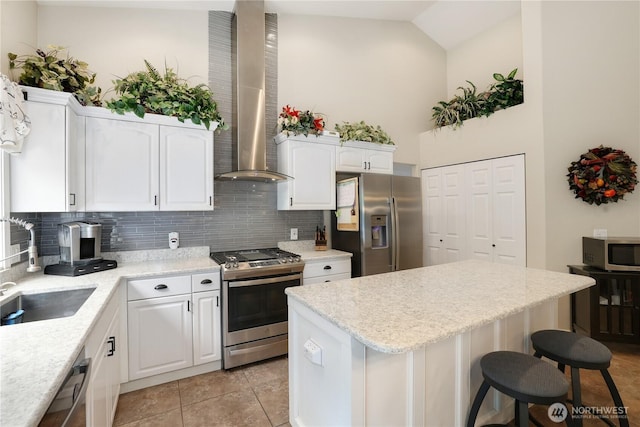 23813 109th Street Ct E, Buckley, WA 98321 - kitchen with appliances with stainless steel finishes, exhaust hood, a sink, a center island, and tasteful backsplash