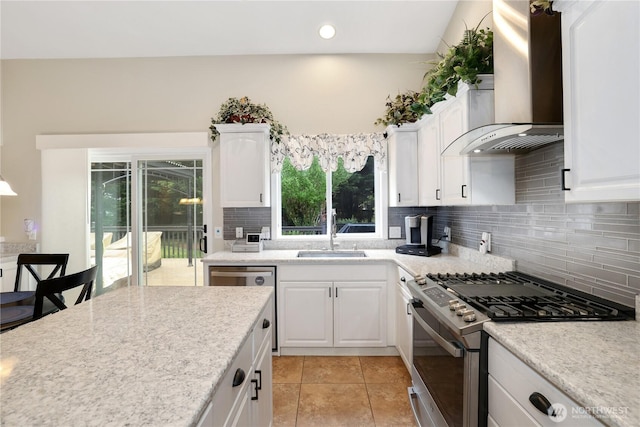 23813 109th Street Ct E, Buckley, WA 98321 - kitchen featuring appliances with stainless steel finishes, wall chimney range hood, a sink, white cabinets, and tasteful backsplash