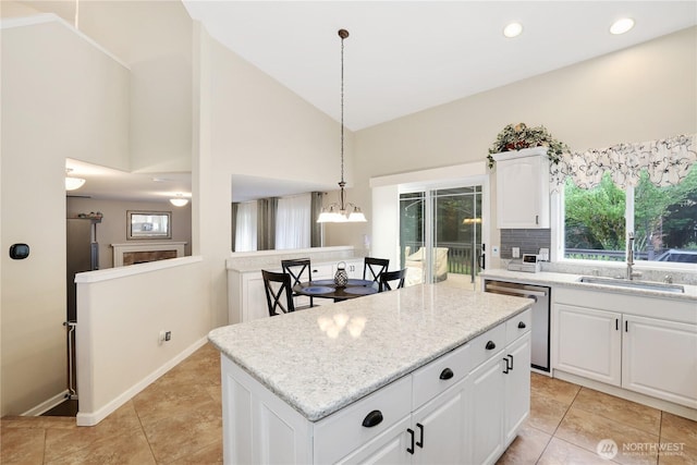 23813 109th Street Ct E, Buckley, WA 98321 - kitchen featuring stainless steel dishwasher, a sink, a center island, high vaulted ceiling, and light tile patterned floors