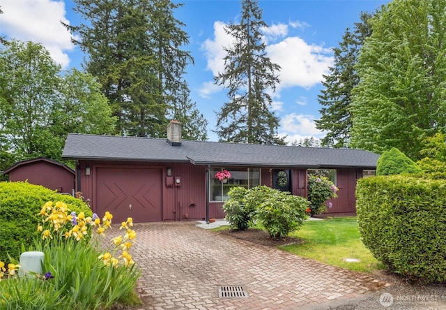 19019 Grannis Rd, Bothell, WA 98012 - view of front of home featuring an attached garage, decorative driveway, and a chimney