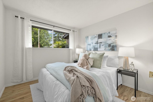19019 Grannis Rd, Bothell, WA 98012 - bedroom featuring light wood-style flooring and baseboards