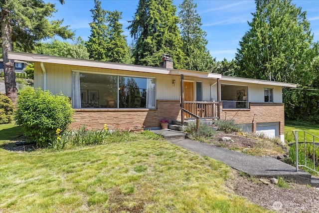 1420 Olympic Ave, Edmonds, WA 98020 - ranch-style home with a front lawn, a chimney, an attached garage, covered porch, and brick siding