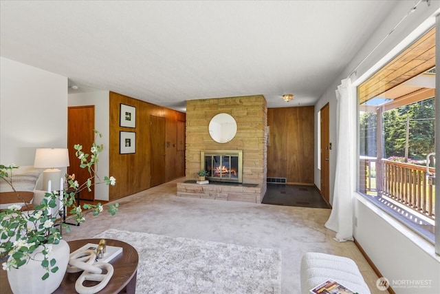 1420 Olympic Ave, Edmonds, WA 98020 - unfurnished living room with wood walls, a fireplace, and carpet flooring