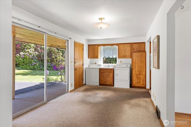 1420 Olympic Ave, Edmonds, WA 98020 - kitchen featuring brown cabinets, light countertops, independent washer and dryer, a sink, and light colored carpet
