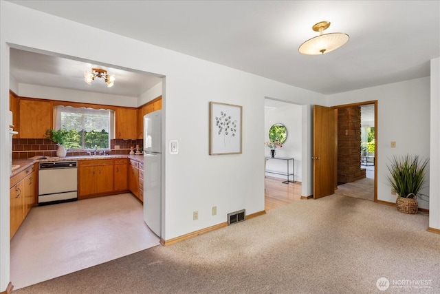 1420 Olympic Ave, Edmonds, WA 98020 - kitchen with white appliances, a sink, decorative backsplash, light carpet, and a baseboard radiator