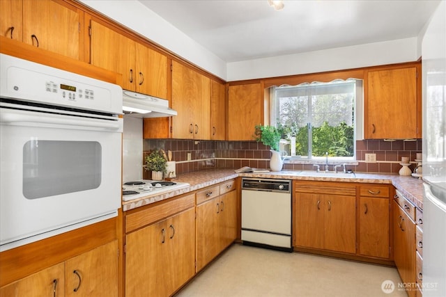 1420 Olympic Ave, Edmonds, WA 98020 - kitchen featuring white appliances, under cabinet range hood, decorative backsplash, and light countertops