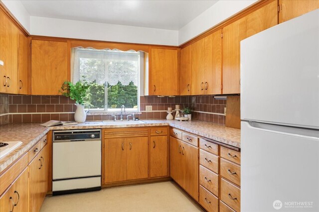1420 Olympic Ave, Edmonds, WA 98020 - kitchen with white appliances, a sink, decorative backsplash, light countertops, and brown cabinets