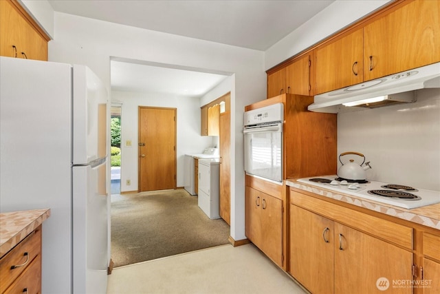 1420 Olympic Ave, Edmonds, WA 98020 - kitchen featuring white appliances, under cabinet range hood, light countertops, light colored carpet, and washer and clothes dryer