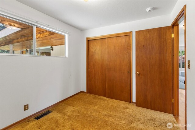 1420 Olympic Ave, Edmonds, WA 98020 - unfurnished bedroom with carpet floors, baseboards, and two closets