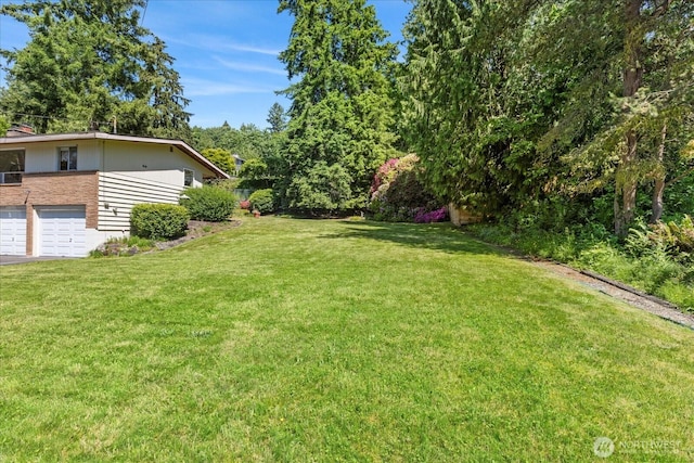 1420 Olympic Ave, Edmonds, WA 98020 - view of grassy yard featuring an attached garage and driveway